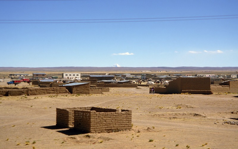 Mt.Sajama far away beyound a town in Altiplano