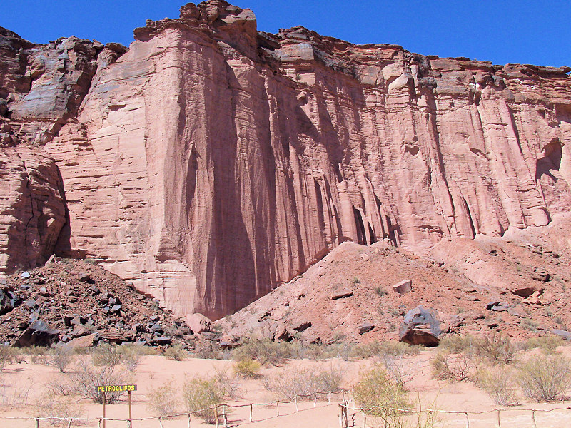 Vertical rock walls and talus cones in the Talampaya River Canyon