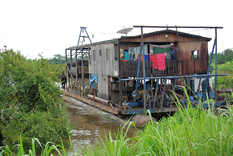 A garimpo raft extracting placer gold from the sediment at the bottom of the river